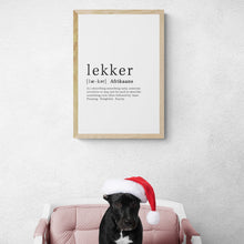 Load image into Gallery viewer, Lekker definition art print in light oak frame with Christmas black puppy on chair 