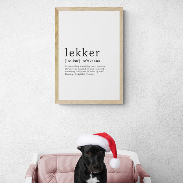 Lekker definition art print in light oak frame with Christmas black puppy on chair 